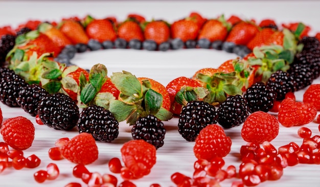 Love symbol heart made from colorful berries.