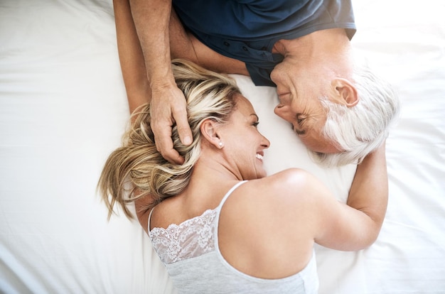 Love you have to feel it to know what it is Shot of an affectionate mature couple lying in bed together at home