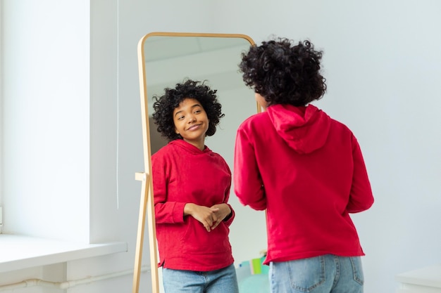 Love yourself beautiful young smiling african american woman dancing enjoying her mirror reflection