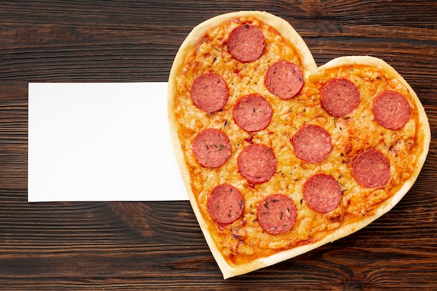 Lovely arrangement for valentines day dinner with heart shaped pizza and card