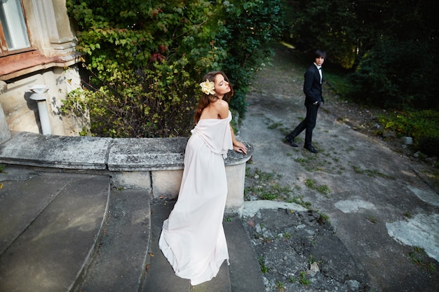 Lovely bride and bridegroom standing close to each other at park background, wedding photo, wedding day,close up portrait.