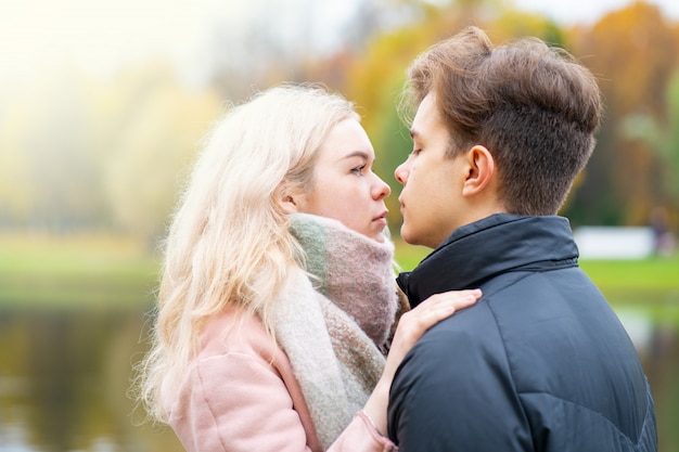 Lovely brunette guy and pretty girl blonde drink coffee and talking on date. Loving teenagers