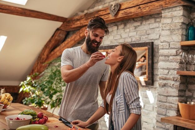 Lovely couple cooking together in the kitchen