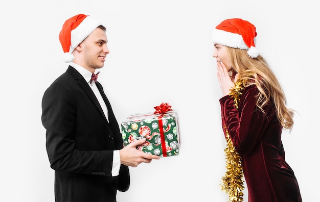 Lovely couple giving Christmas gifts