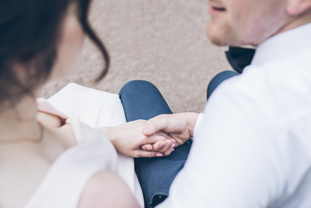 Lovely couple holds each other hands