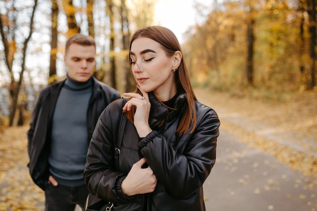 Lovely couple posing in autumn forest, lovers walking in park