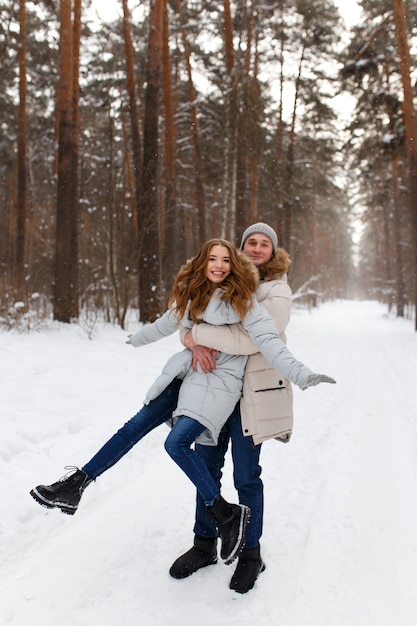 lovely couple walks in the winter forest