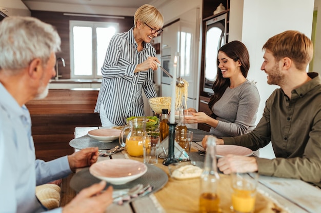 Lovely family enjoying weekend at home and having lunch together