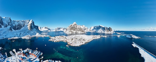 Lovely fishing village, Reine, surrounded by mountains in the Lofoten Islands, Norway. Aerial view. Panoramic image. Breathtaking winter landscape.