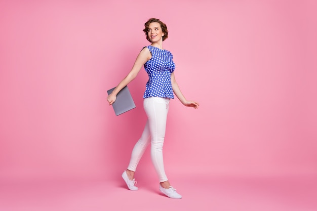 lovely girl carrying laptop walk