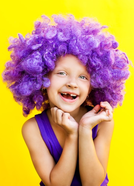 Lovely girl in a purple wig showing happy emotions