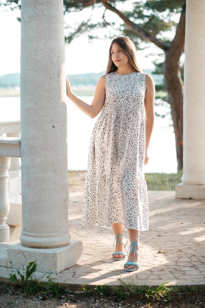 Lovely girl in summer dress outdoors