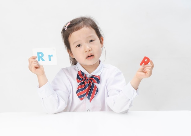 The lovely little girl is learning letters