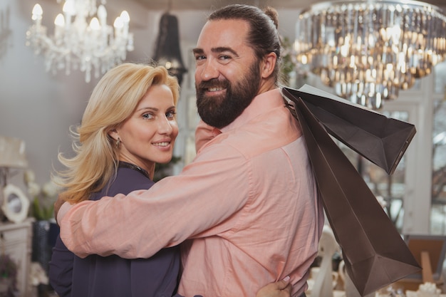 Lovely mature couple buying kitchenware at the store