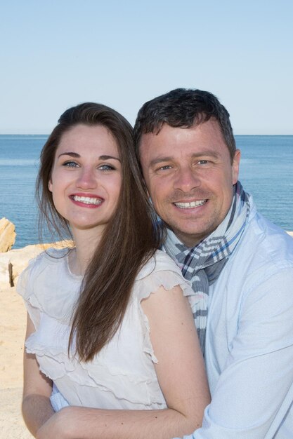 Lovely newly couple at the beach smiling