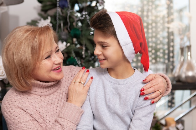 Lovely senior woman celebrating Christmas with her grandson