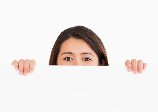 Lovely woman hidding behind a board