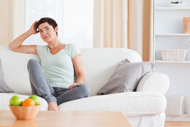 Lovely woman sitting on a sofa