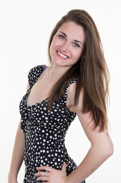 Lovely woman standing in black and white dress isolated on white