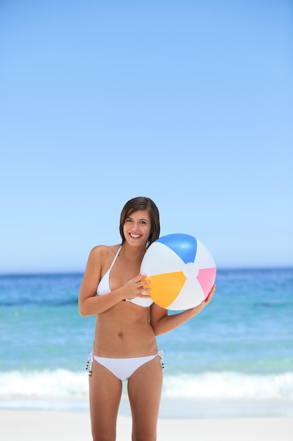 Lovely woman with her ball on the beach