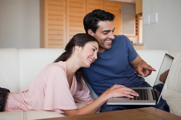 Lovely young couple using a laptop