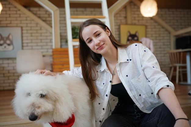 Lovely young woman playing with her dog