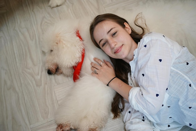 Lovely young woman playing with her dog