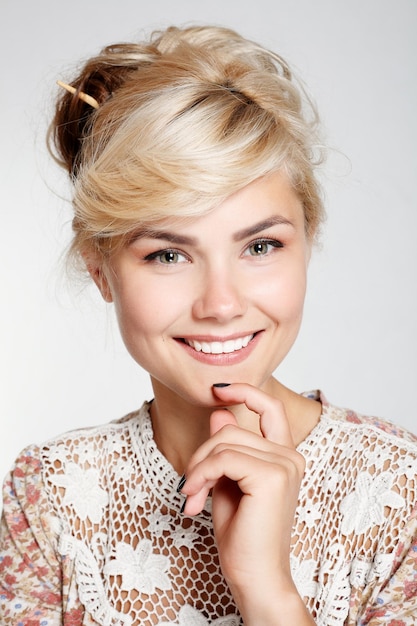 Lovely young woman smiling in studio