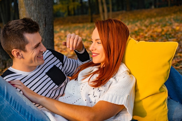 Lovers man and woman in the park in autumn