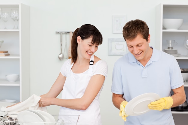 Lovers washing dishes together