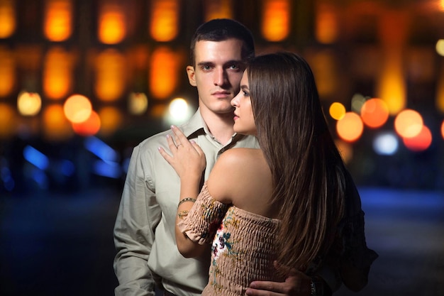 Lovestory portraits among streetlights