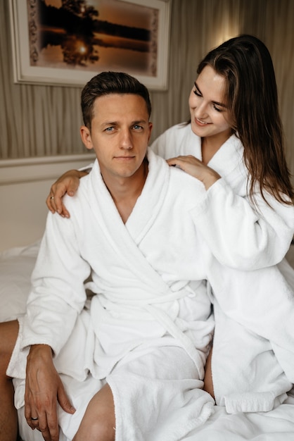 Loving couple in bathrobes in a hotel room