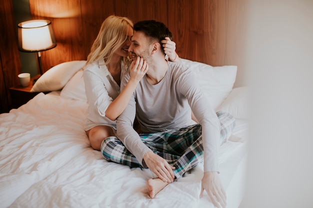 Photo loving couple on the bed in the bedroom