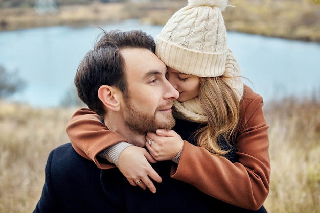 Loving couple embracing in the field, autumn 