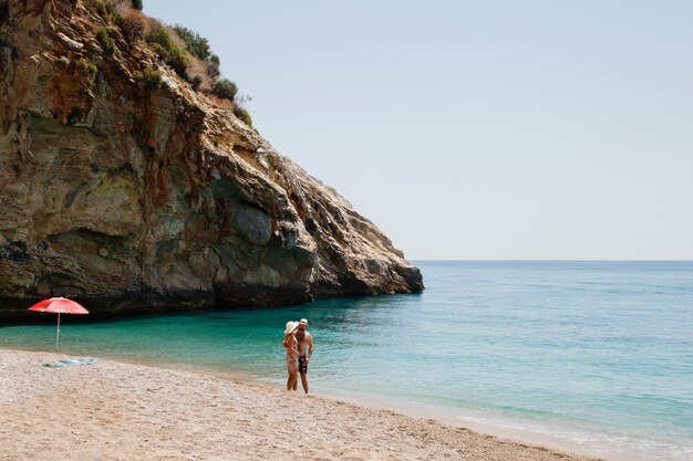 Loving couple enjoying honeymoon on beach in laguna with luxury view walking on sea