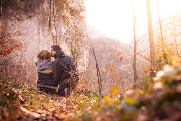 Photo loving couple enjoys the mountain view beautiful scenery with sundown autumn