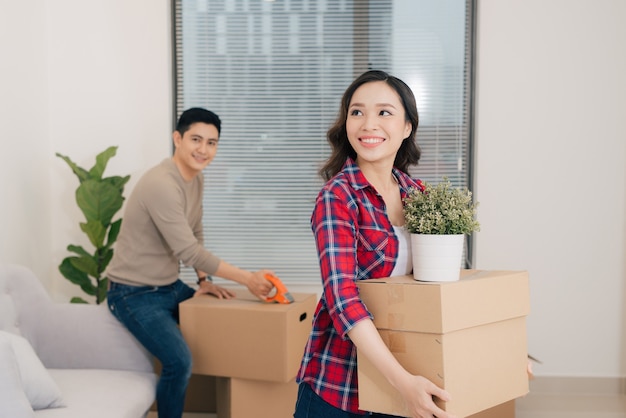 Loving couple enjoys a new apartment and keep the box in hands