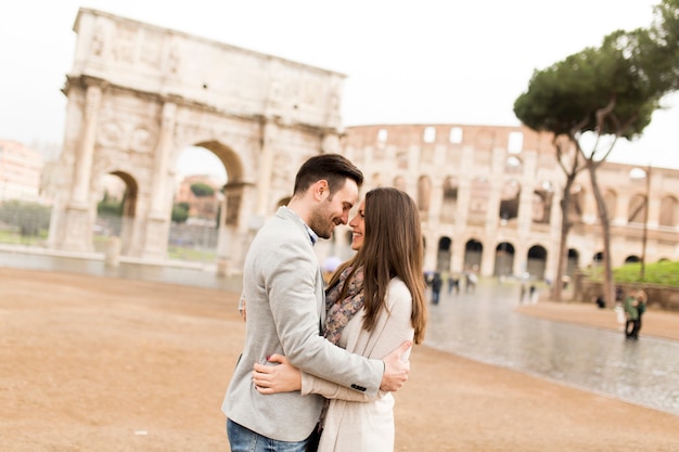 Loving couple in front of the Colosseum in Rome