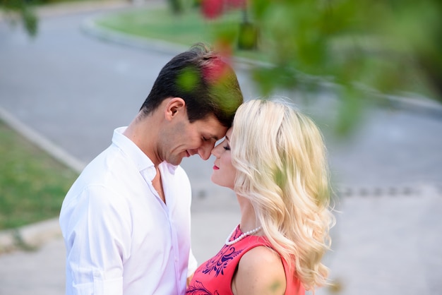 A loving couple hugs and walks in the park.