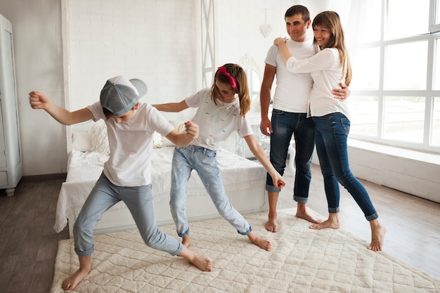 Photo loving couple looking at their children's dance at home