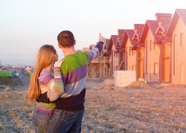 Loving couple looking at their home