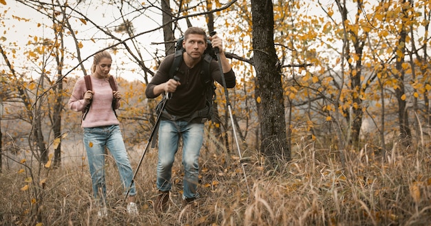 Loving couple makes their way through thicket