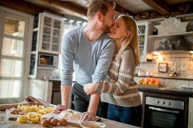 Loving couple preparing pasta in the kitchen