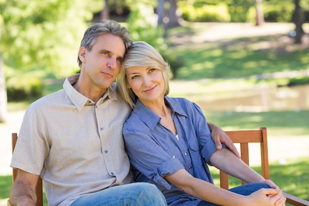 Loving couple relaxing on park bench