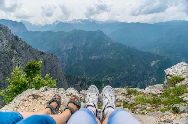 Loving couple resting on the top of the mountain after climbing