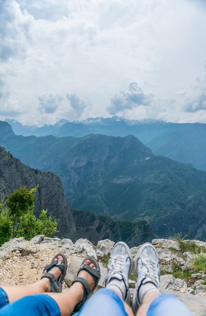 Loving couple resting on the top of the mountain after climbing