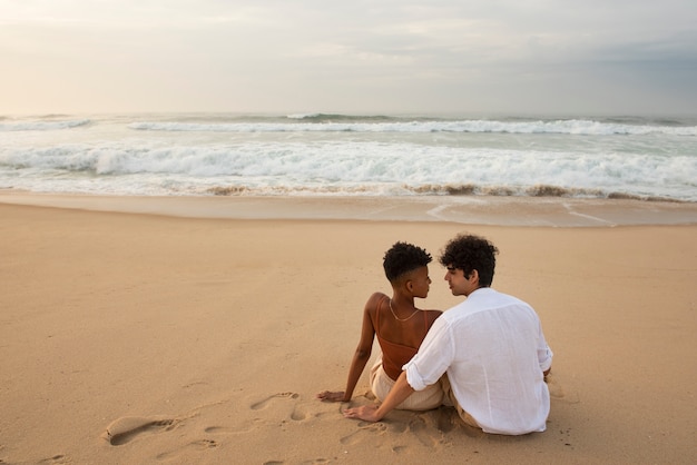 Loving couple showing affection on the beach near the ocean