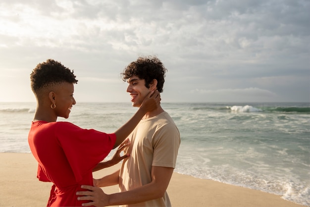 Loving couple showing affection on the beach near the ocean