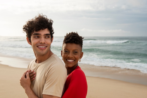 Loving couple showing affection on the beach near the ocean