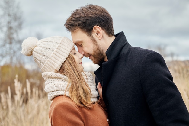 Loving couple walking in Park in autumn hugs and kisses.